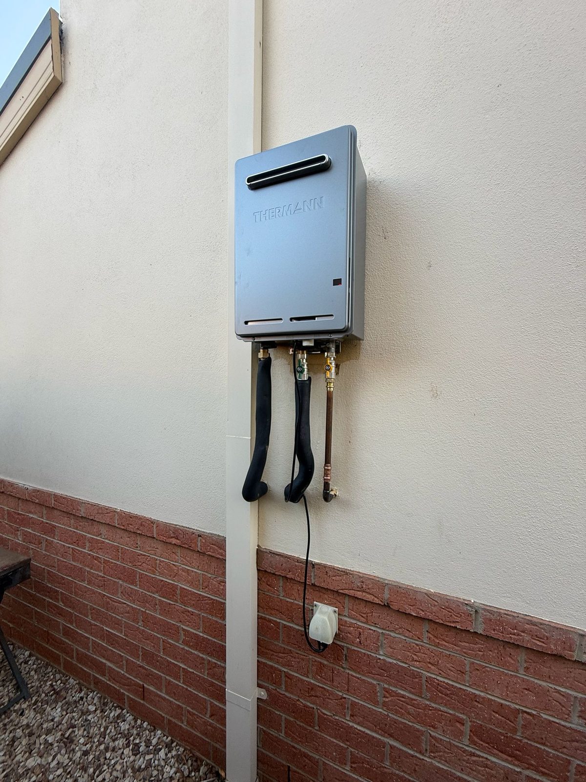 Continuous flow hot water system on external rendered wall Williamstown